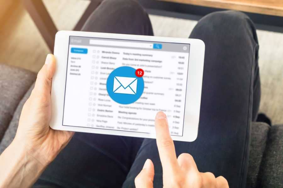 A person looking at emails on their tablet. 
