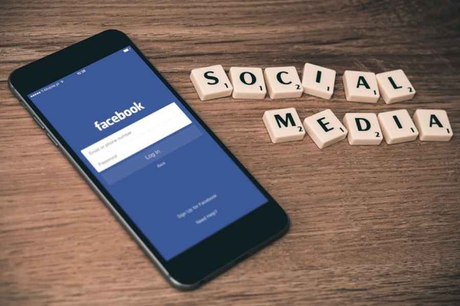 Phone screen showing facebook login with social media spelled out in tiles