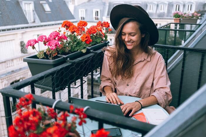 what is a freelancer woman working on scenic balcony